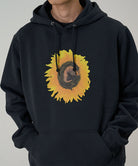 Black hoodie with a sunflower design on a gray background