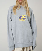 Gray sweatshirt with a logo worn by a person on a plain background
