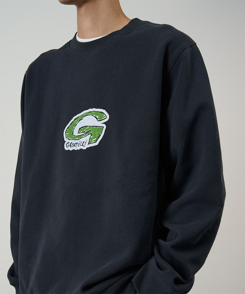 Black sweatshirt with a green and white logo on a neutral background