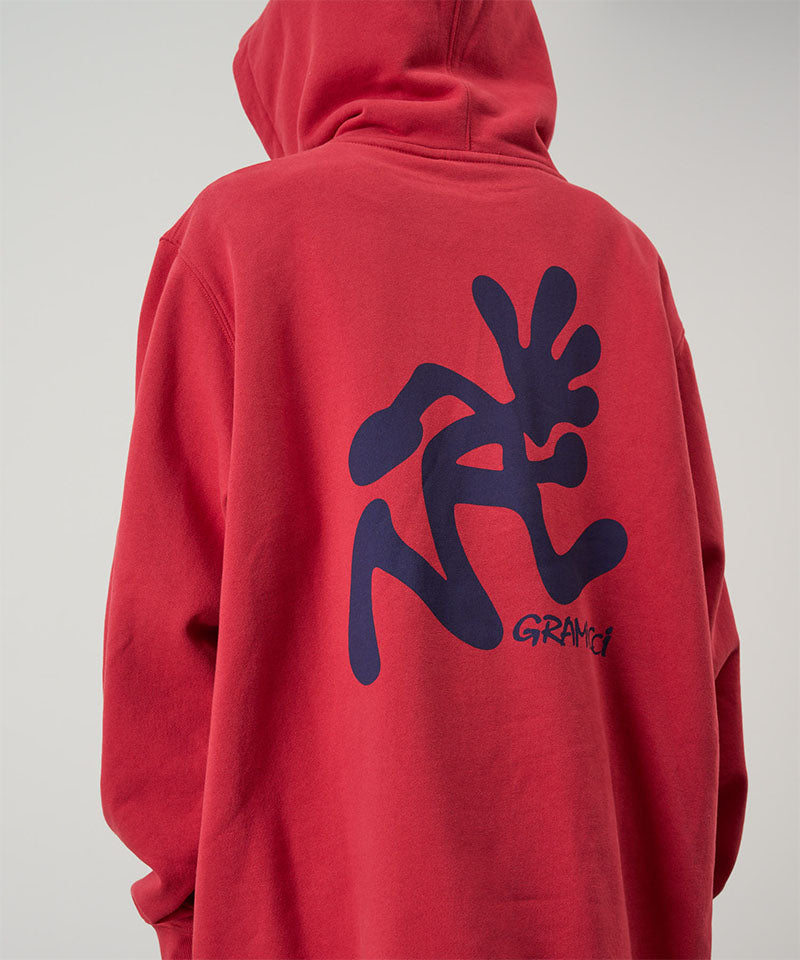 Red hoodie with black abstract design on the back against a gray background