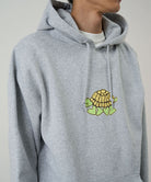 Gray hoodie with a turtle graphic on the chest against a neutral background