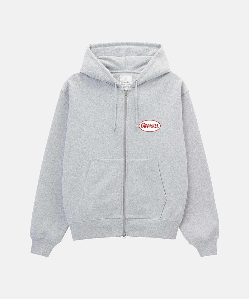Gramicci heather grey Oval Patch Zip Hooded Sweatshirt with a red and white patch against a light-tone background.