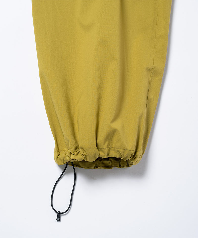 Close-up of the adjustable hem drawstring on olive Gramicci DWR Field Pants