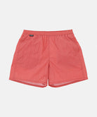 Front view of red checked Gramicci Grid Swim Shorts against a light-tone background.
