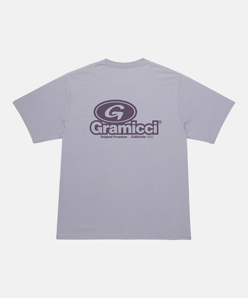 Back view of a Gramicci light lavender '82 Tee with dark lavender graphic against a light tone background.