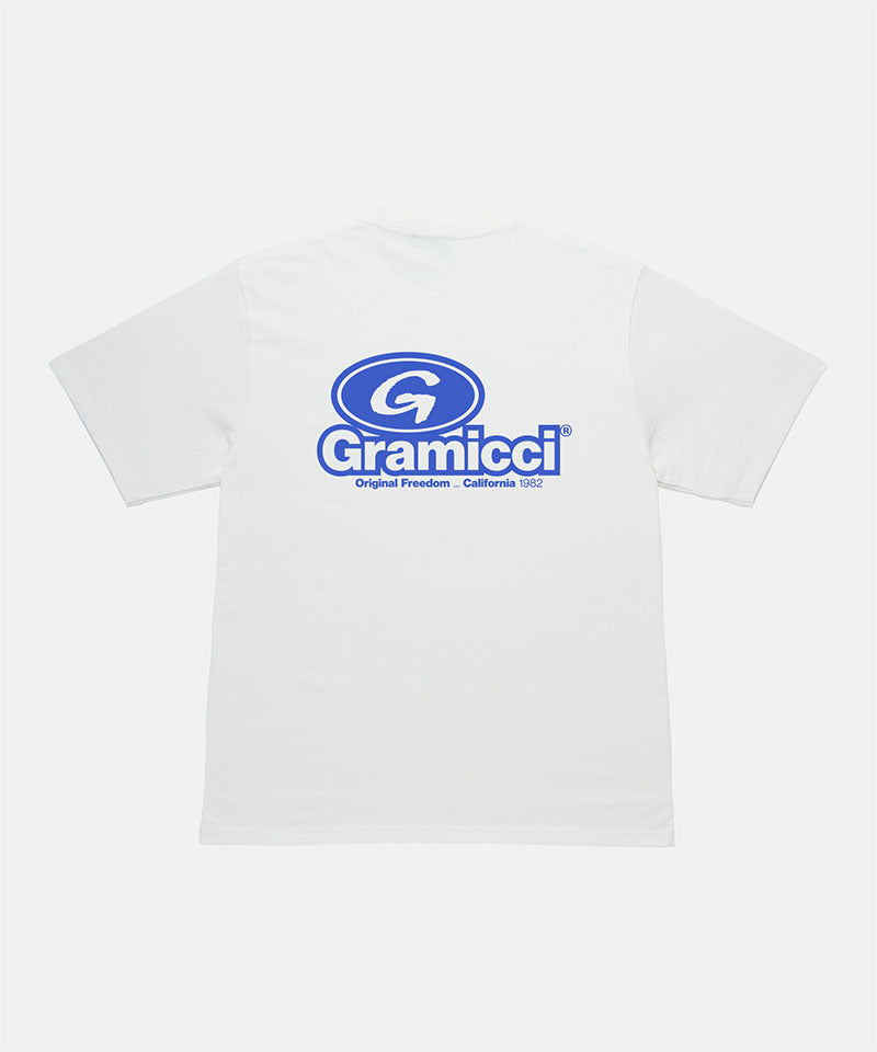 Back view of a Gramicci white '82 Tee with blue graphic against a light tone background.