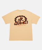 Back view of a Gramicci mango colored Equipped For Dirt Tee with a graphic against a light-tone background.