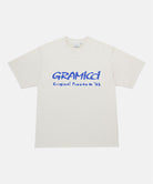 Gramicci natural pigment Freedom Tee Pigment Dyed with blue graphic against a light tone background.