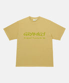 Gramicci yellow sulpher pigment Freedom Tee Pigment Dyed with lime green graphic against a light tone background.