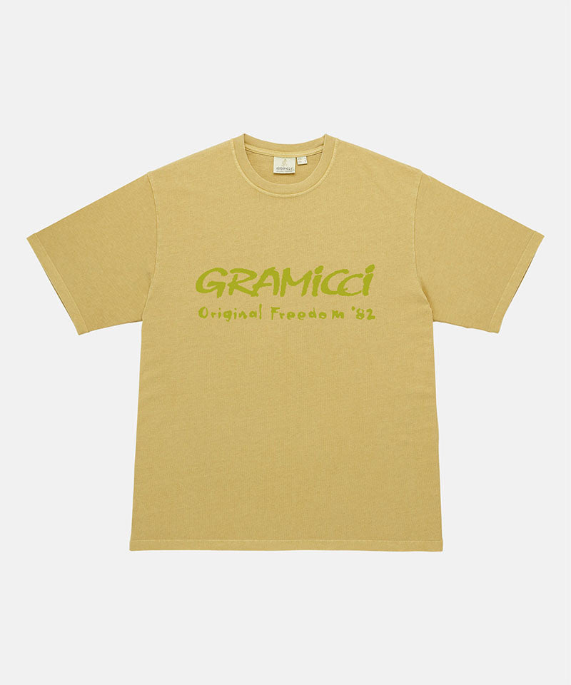 Gramicci yellow sulpher pigment Freedom Tee Pigment Dyed with lime green graphic against a light tone background.