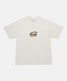 Gramicci natural colored G-Scribble Tee Pigment Dyed shirt with purple graphic against a light tone background.
