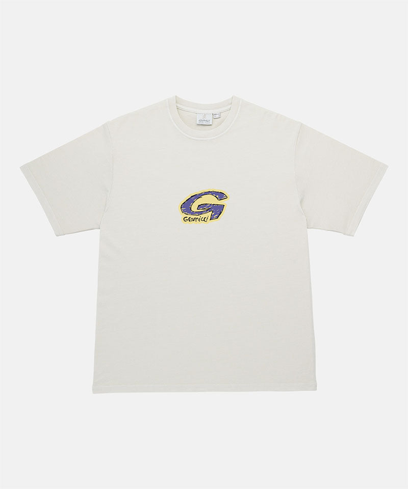 Gramicci natural colored G-Scribble Tee Pigment Dyed shirt with purple graphic against a light tone background.
