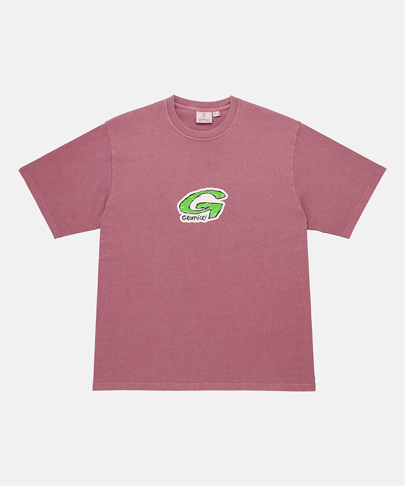 Gramicci red G-Scribble Tee Pigment Dyed shirt with green graphic against a light tone background.

