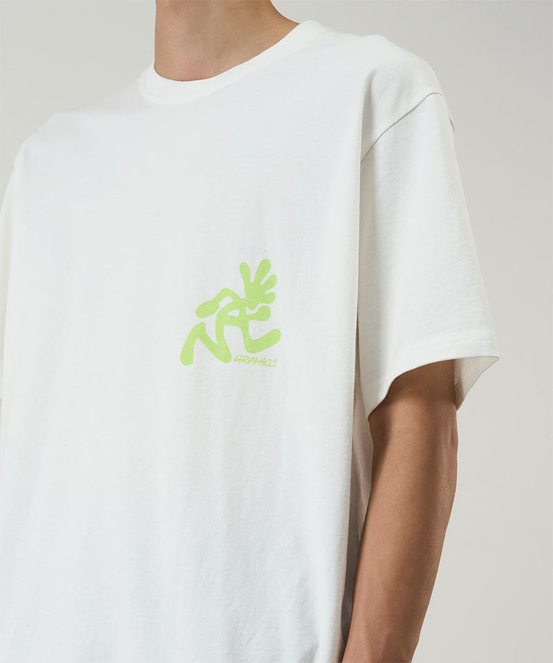 White t-shirt with green logo worn by a person on a plain background
