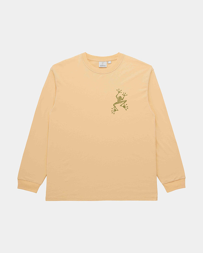Gramicci mango colored Sticky Hands L/S Tee with green frog graphic against a light tone background.