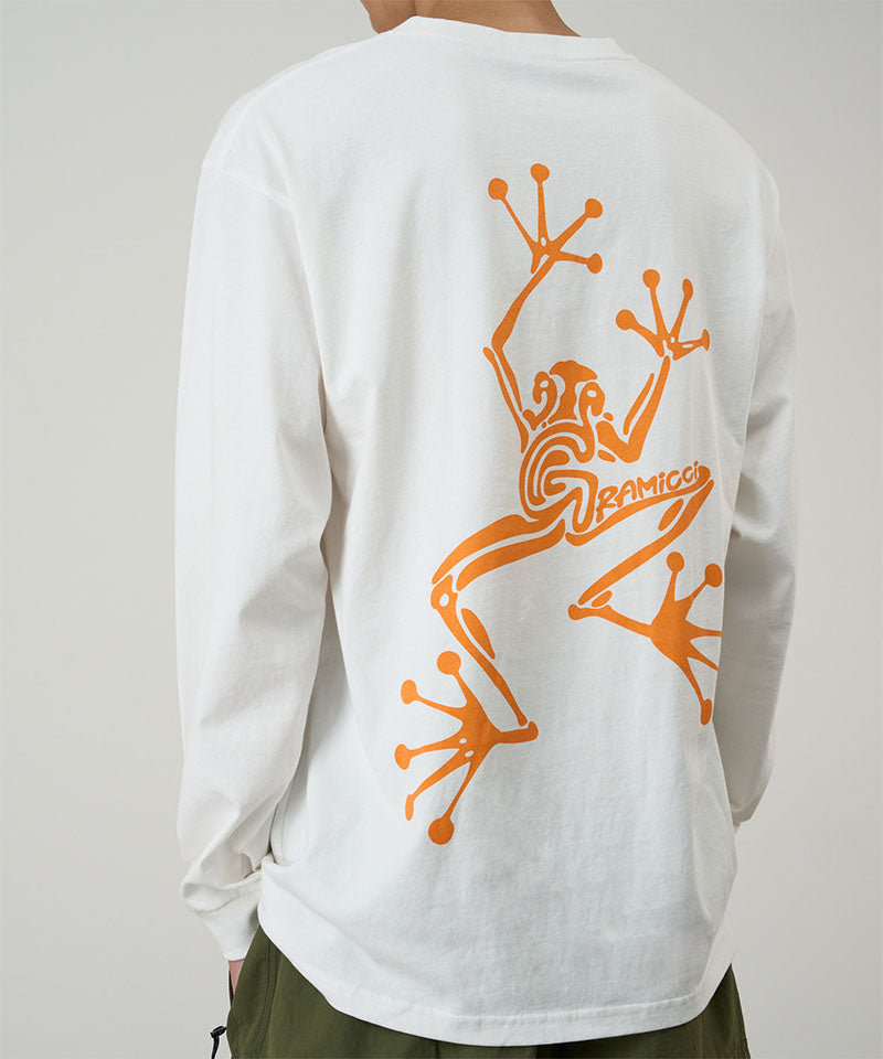 Model wearing a Gramicci white Sticky Hands L/S Tee with orange frog graphic against a light tone background.