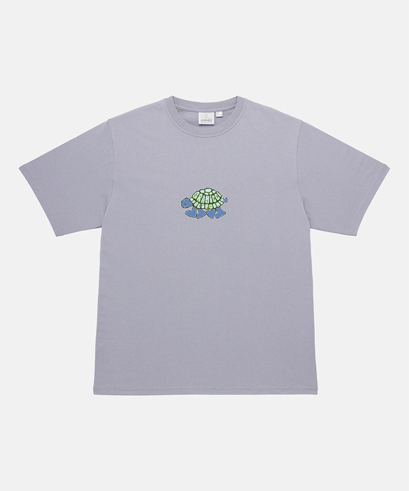Gramicci lavender Turtle Tee with a turtle graphic against a light tone background.

