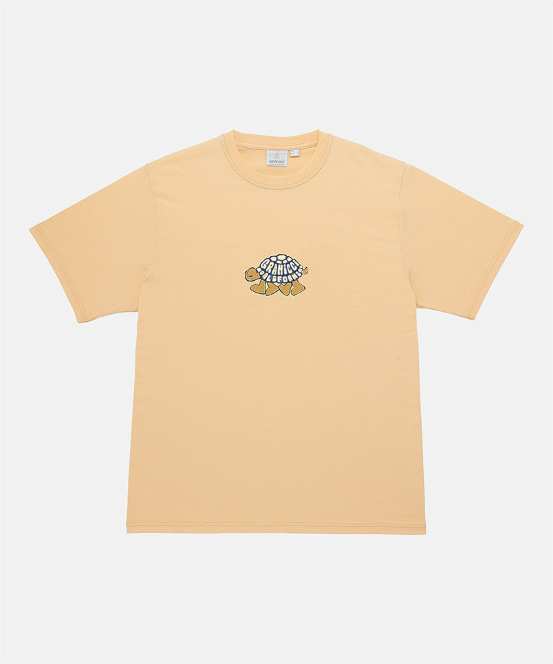 Gramicci mango Turtle Tee with a graphic against a light tone background.
