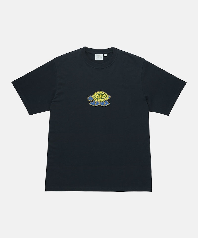 Gramicci vintage black Turtle Tee with a turtle graphic against a light-tone background.