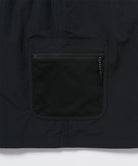 Close-up of Gramicci Guide Skort pocket in the color black against a light-tone background.