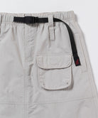 Beige skirt with a black belt and pocket detail on a white background
