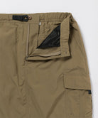 Close-up of Gramicci Convertible Cargo Skirt in the color khaki against a light-tone background.