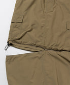 Close-up of Gramicci Convertible Cargo Skirt in the color khaki against a light-tone background.