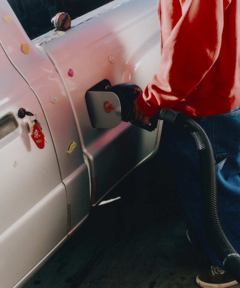 Person refueling a truck with Gramicci Hotel Chain and Rock Hold Magnets.