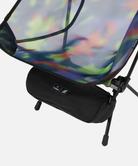 Close-up view of a bright camo Gramici &Helinox Chair One and bag on a light-tone background.